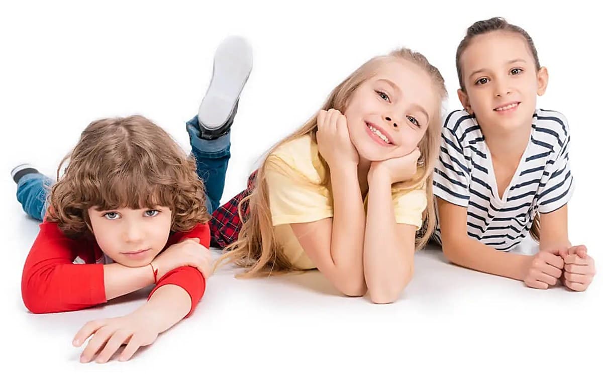 Cheerful kids playing together on the floor