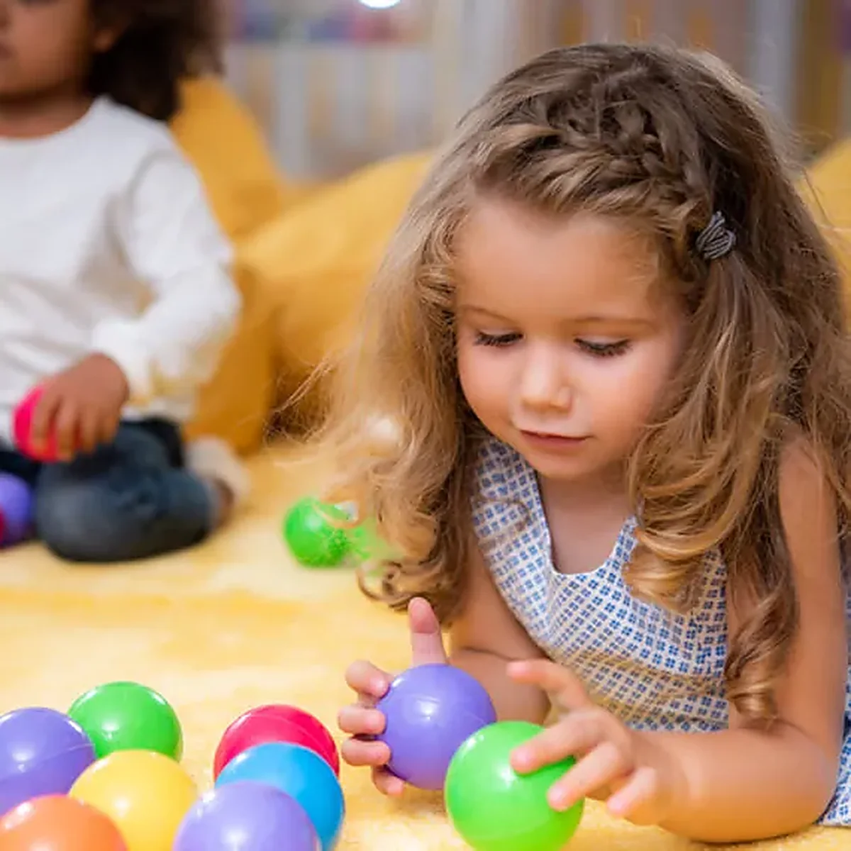 Kids playing with colorful balls